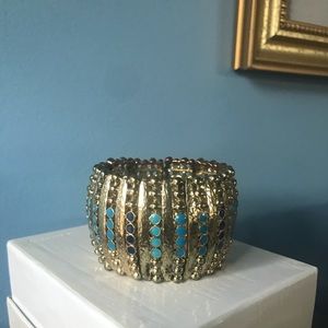 Set: Silver & Gold Colored earring and Gold Colored Bracelet.